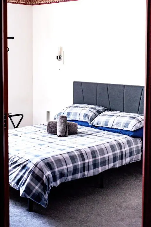 a bedroom with a bed with two pillows on it at Weston House in Keith