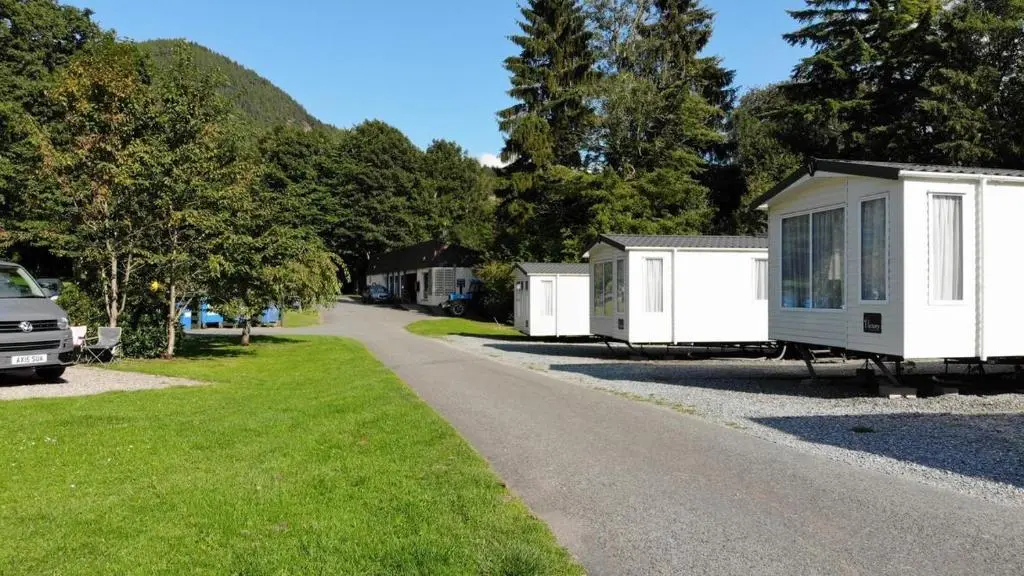 a row of mobile homes parked on the side of a road at Faskally Woods Holiday Park in Pitlochry