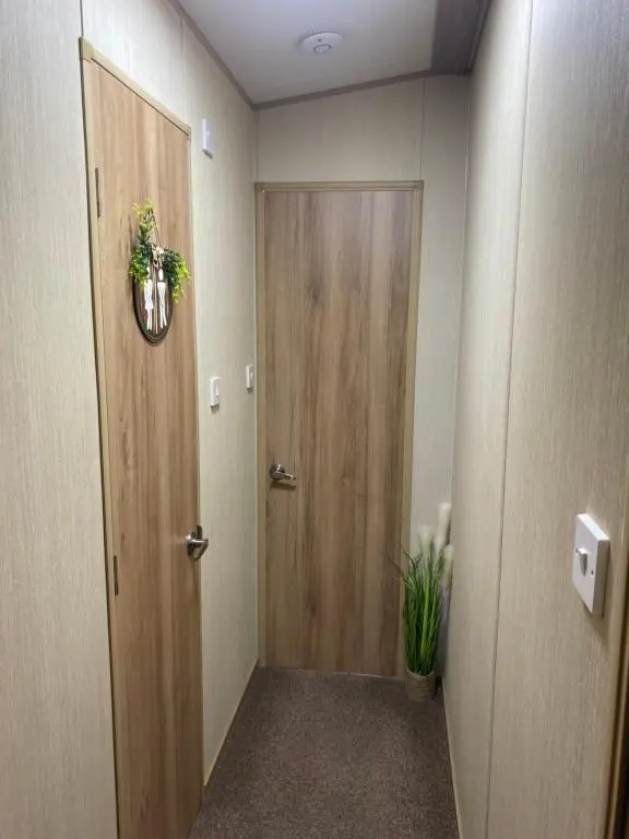 a hallway with a door and a potted plant at The mountain retreat in Aviemore