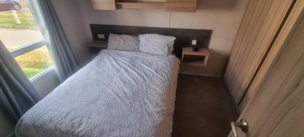 a small bed in a small room with a window at swift LOIRE in Evanton