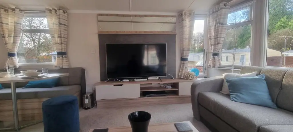 a living room with a flat screen tv and a couch at swift LOIRE in Evanton