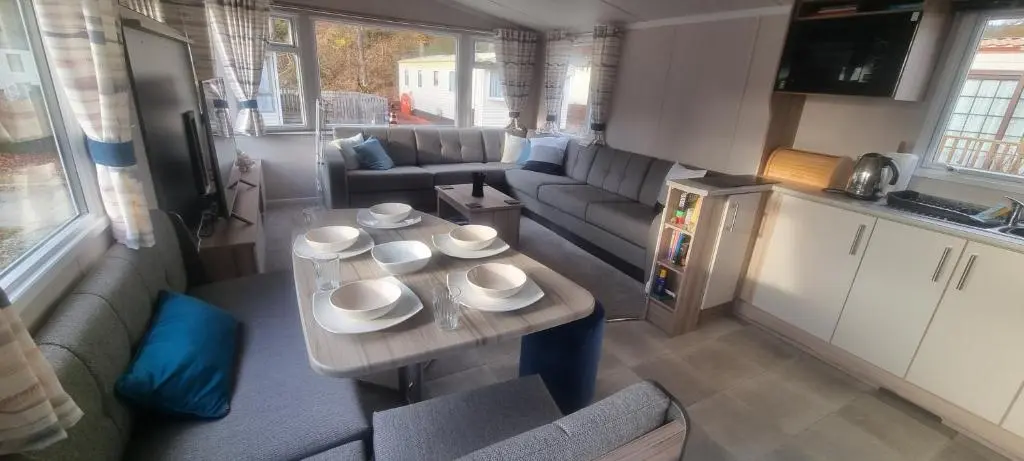 a living room with a table with bowls and plates on it at swift LOIRE in Evanton