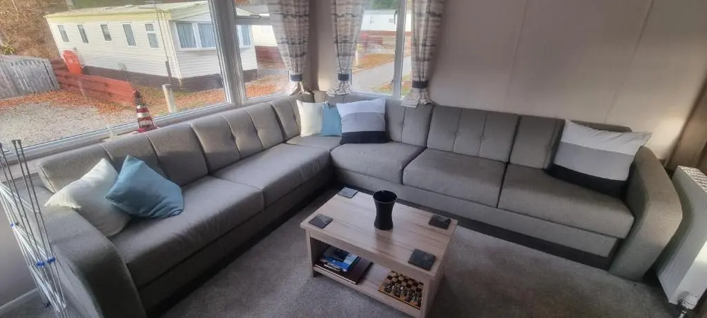a living room with a couch and a table at swift LOIRE in Evanton