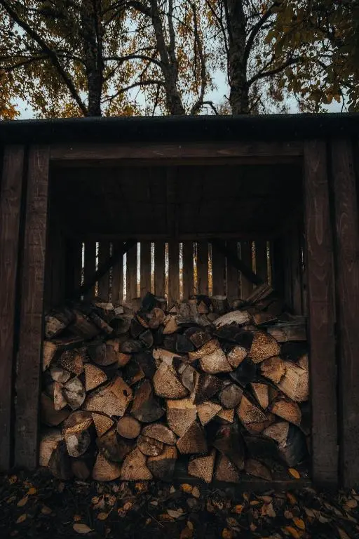 a pile of logs in a wooden shed at Ancarraig Lodges in Drumnadrochit