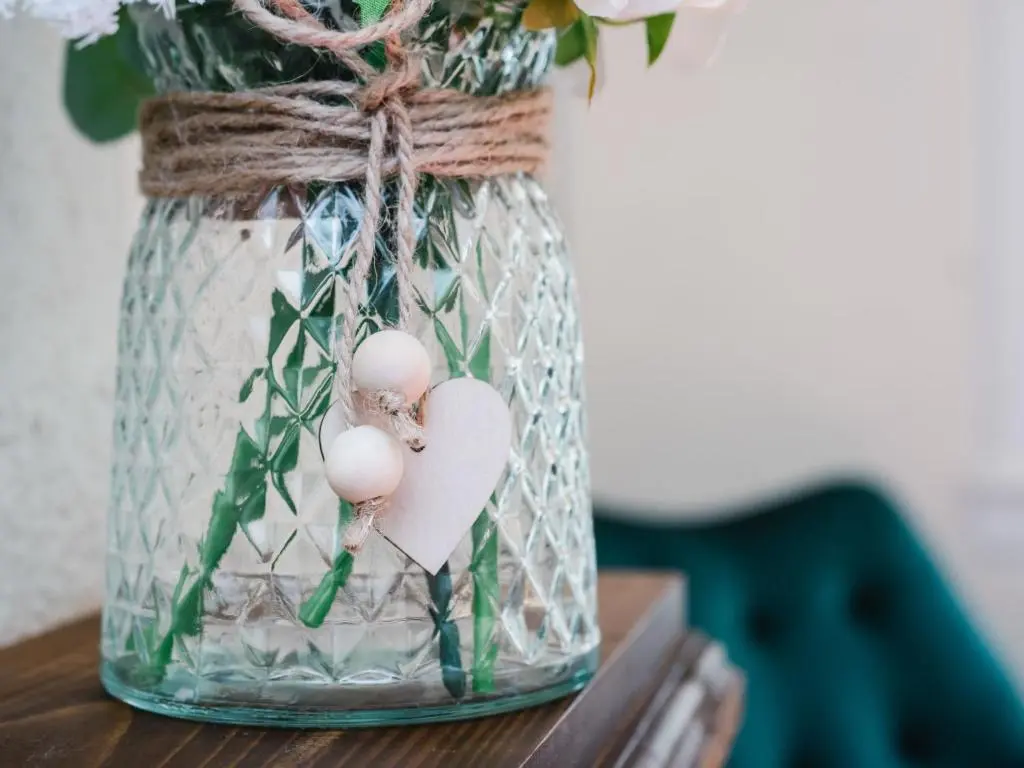 a glass jar with a heart and flowers in it at Holiday Home Jenkins Cottage by Interhome in Fort Augustus