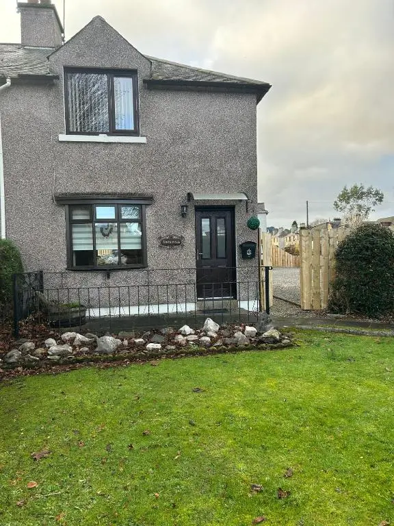a house with a black door and a fence at 2 Bedroom Sheneval House Free Parking in Inverness
