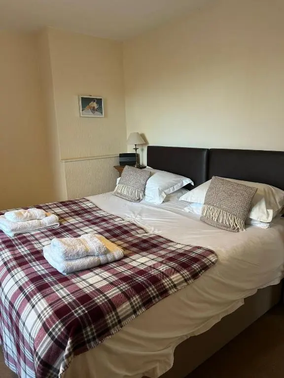 a large bed with two pillows on top of it at 2 Bedroom Sheneval House Free Parking in Inverness