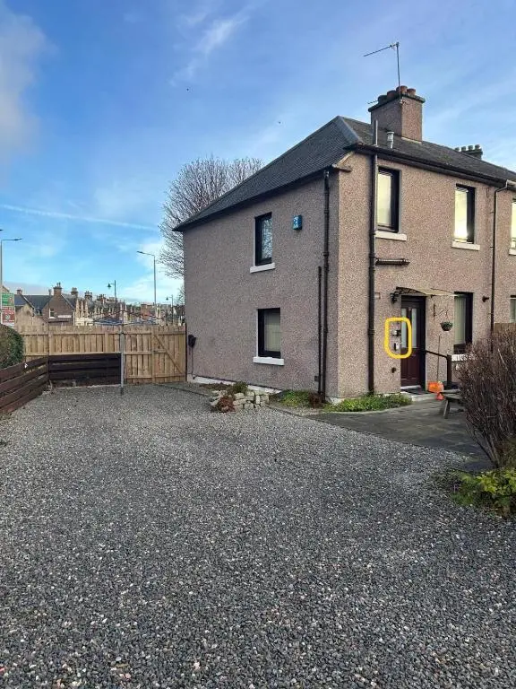 a house on a gravel driveway with a fence at 2 Bedroom Sheneval House Free Parking in Inverness