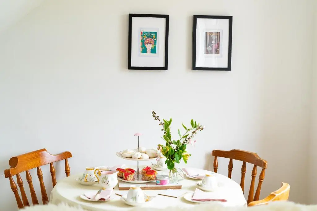 a dining room table with a white table cloth at Carley's House, Macduff in Macduff