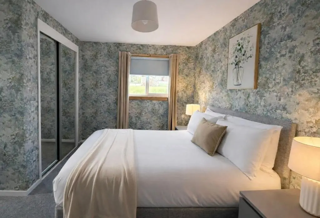 a bedroom with a bed and a window at Charlie's View in Inverness