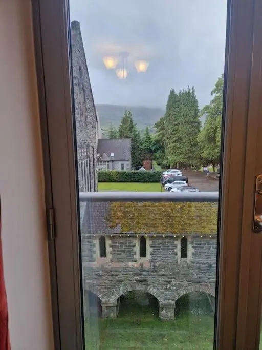 a window with a view of a brick building at Glen Mor in Fort Augustus