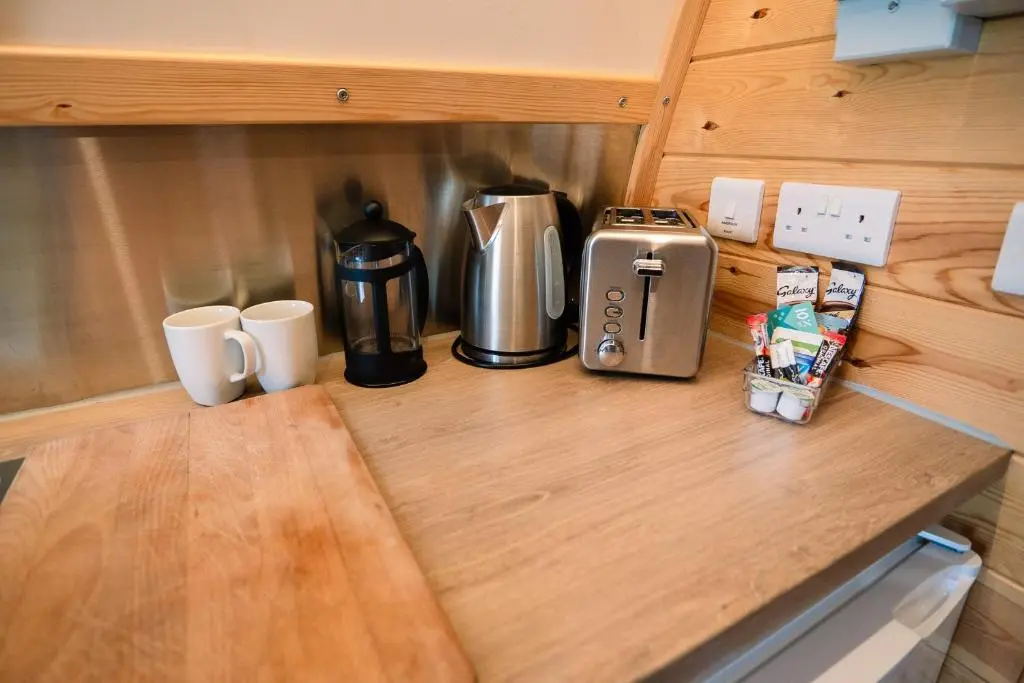 a kitchen counter with a coffee maker and two mugs at The Loft by Wigwam Holidays in Kinloss