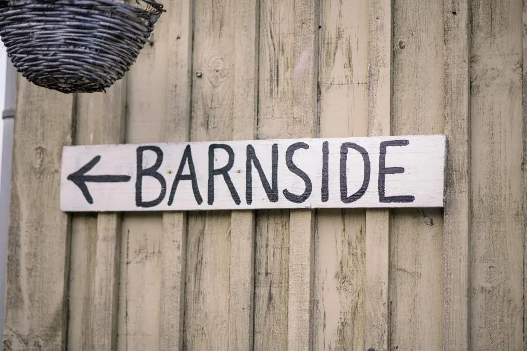 a sign on the side of a wooden wall at The Loft by Wigwam Holidays in Kinloss