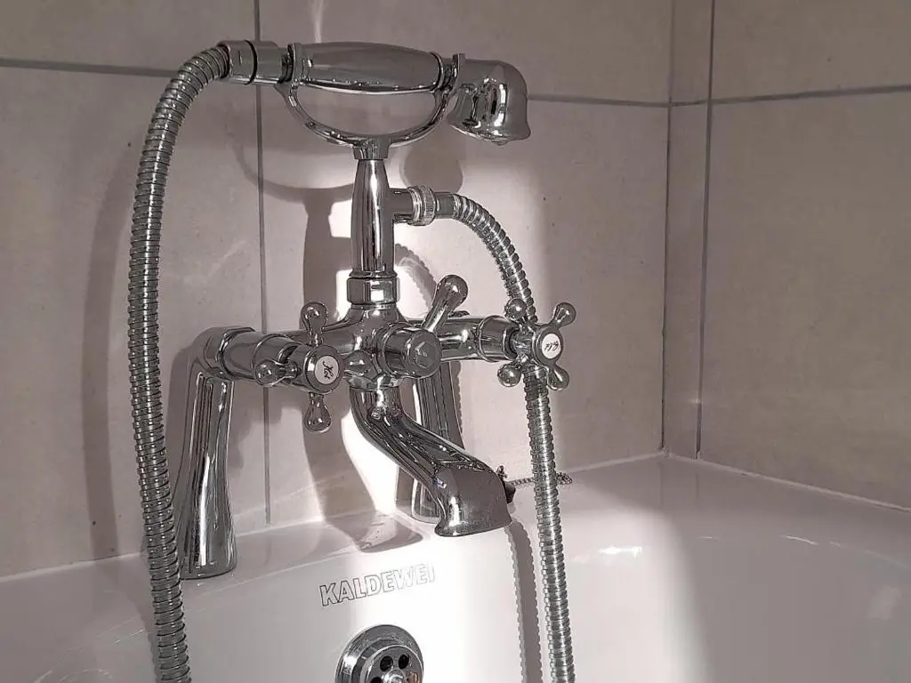 a metal faucet on a sink in a bathroom at The Granary in Buckie