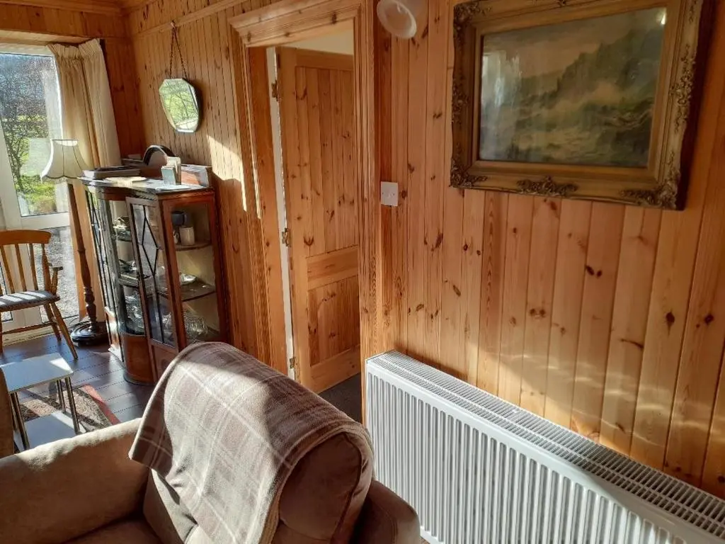 a living room with a couch and a picture on the wall at The Granary in Buckie