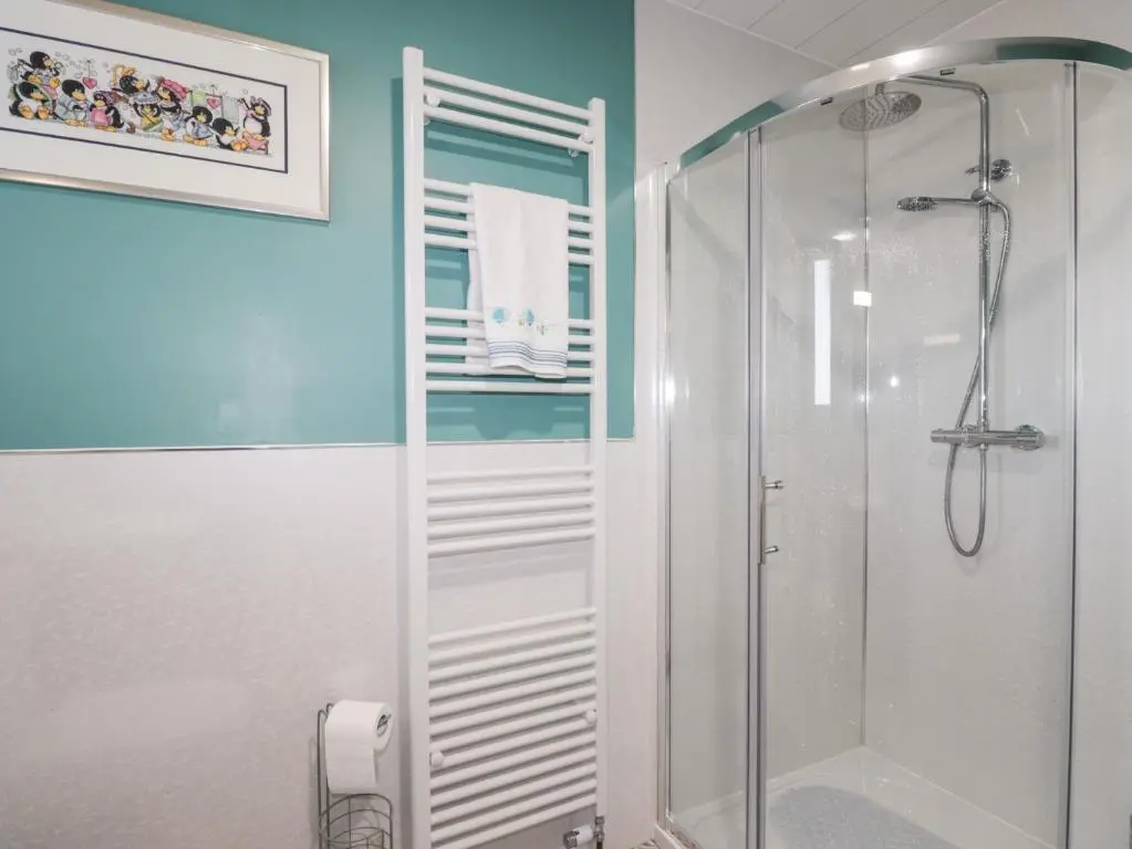 a bathroom with a shower with a glass door at Avemar in Buckie