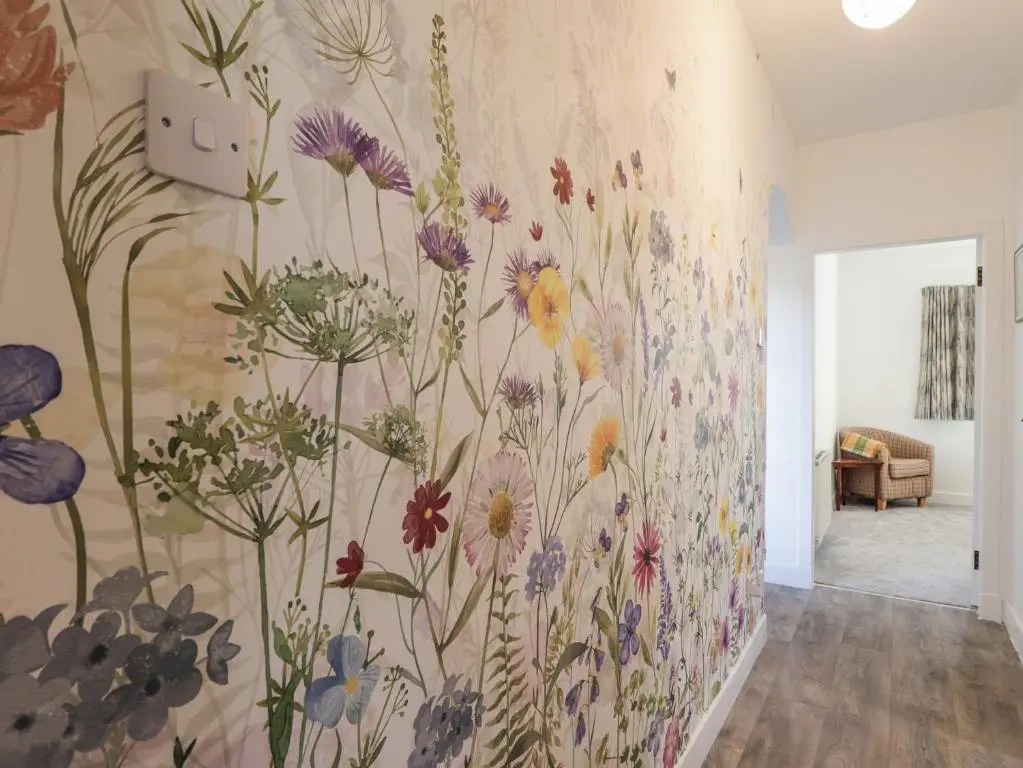 a mural of flowers on a wall in a room at Avemar in Buckie