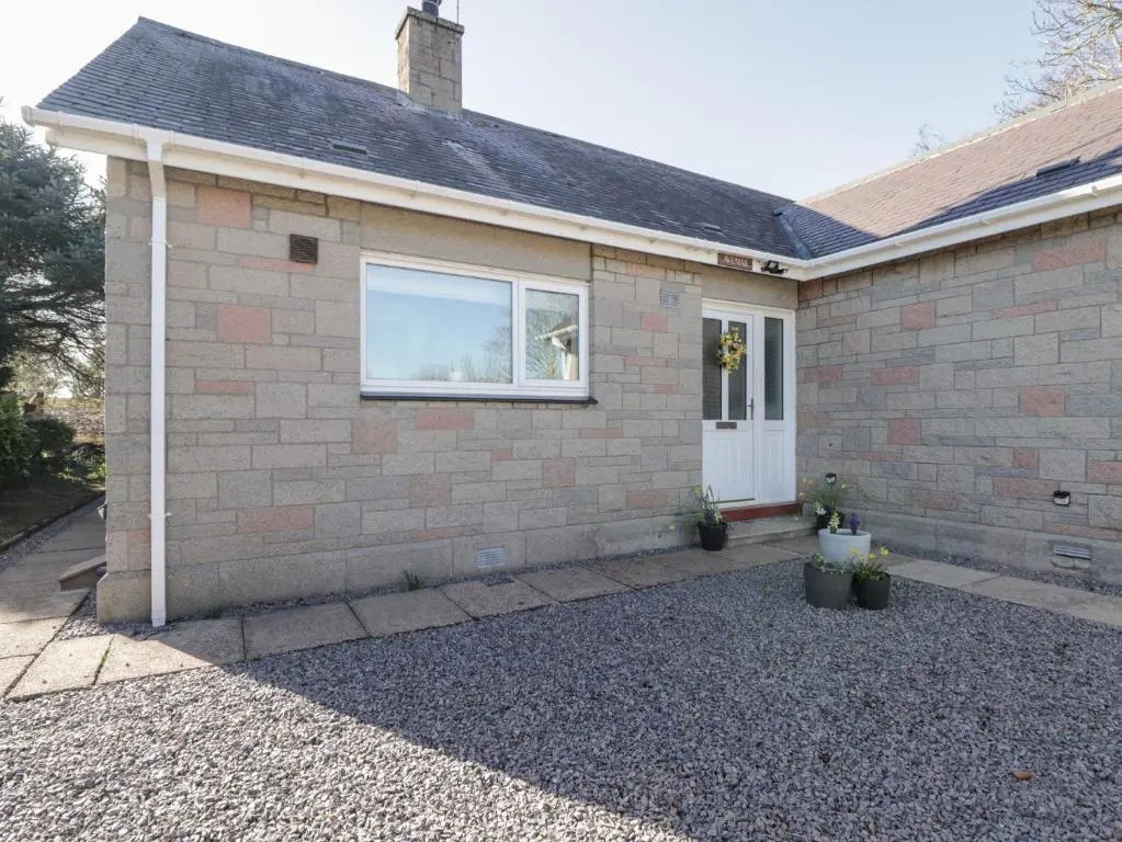 a brick house with a window and a driveway at Avemar in Buckie