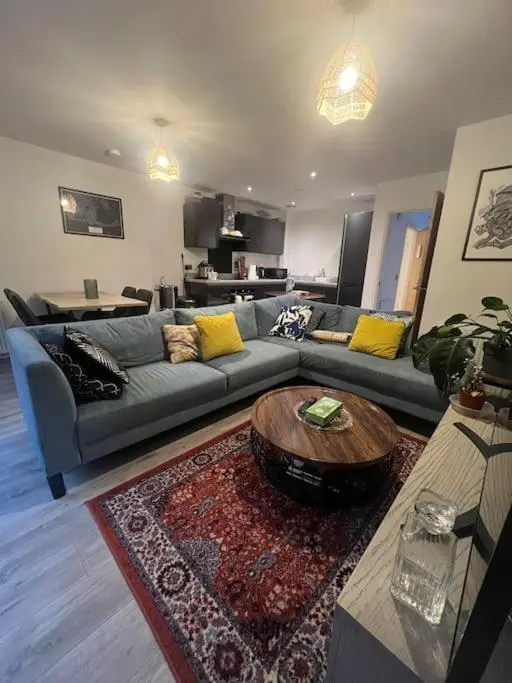 a living room with a couch and a coffee table at Lovely 2 bedroom home, free parking, 6 mins from airport in Bankhead