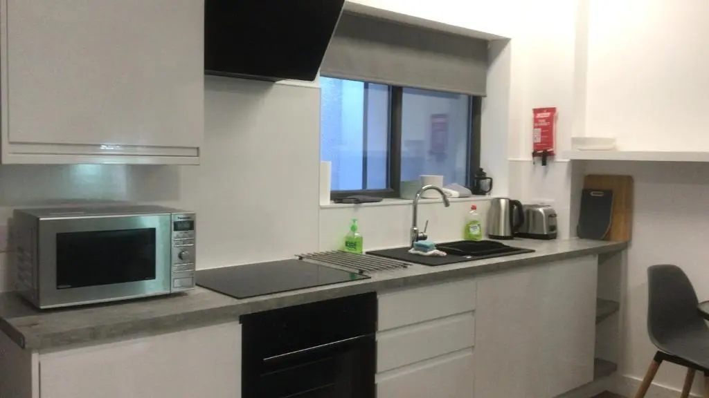 a kitchen with a microwave oven and a sink at Elgin Studios in Elgin