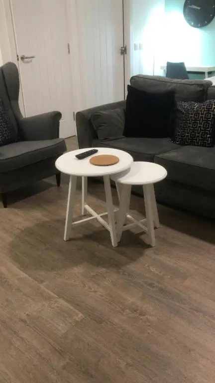 a white coffee table in a living room with a couch at Elgin Studios in Elgin