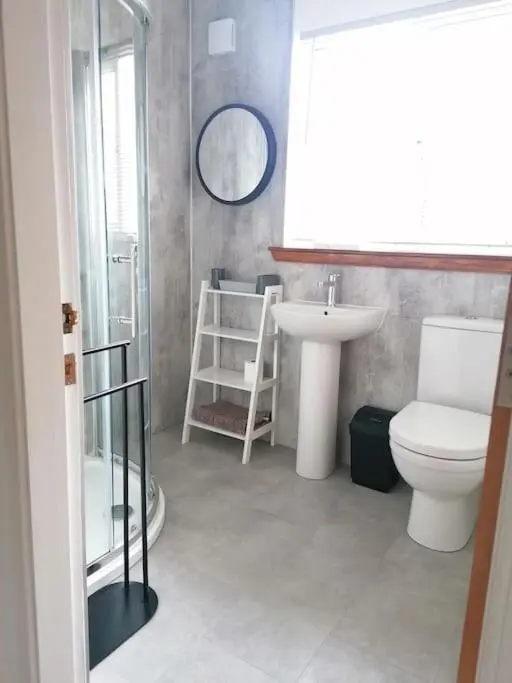 a bathroom with a toilet and a sink at House in Alness in Alness