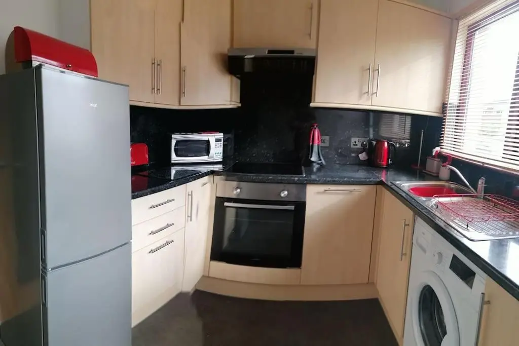 a kitchen with a white refrigerator and a microwave at House in Alness in Alness