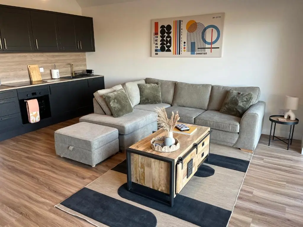 a living room with a couch and a coffee table at Thrumster Lodges - 3 Luxurious Self Catering Lodges on the NC500, 2 with Hot Tubs in Wick
