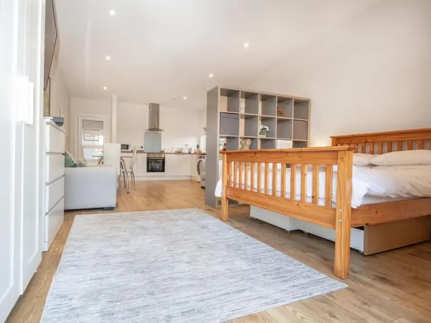 a bedroom with a bed and a living room at View Apartment in Inverness