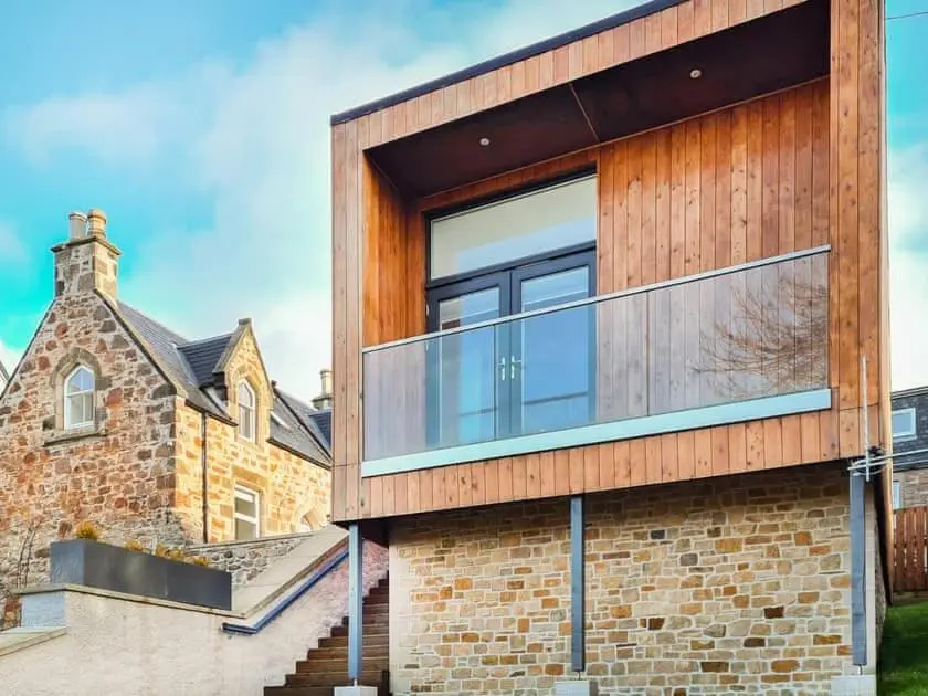 a house with a large window on the side of it at View Apartment in Inverness
