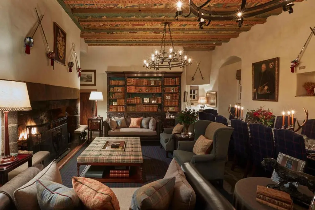 a large living room with couches and a fireplace at Forter Castle in Blairgowrie