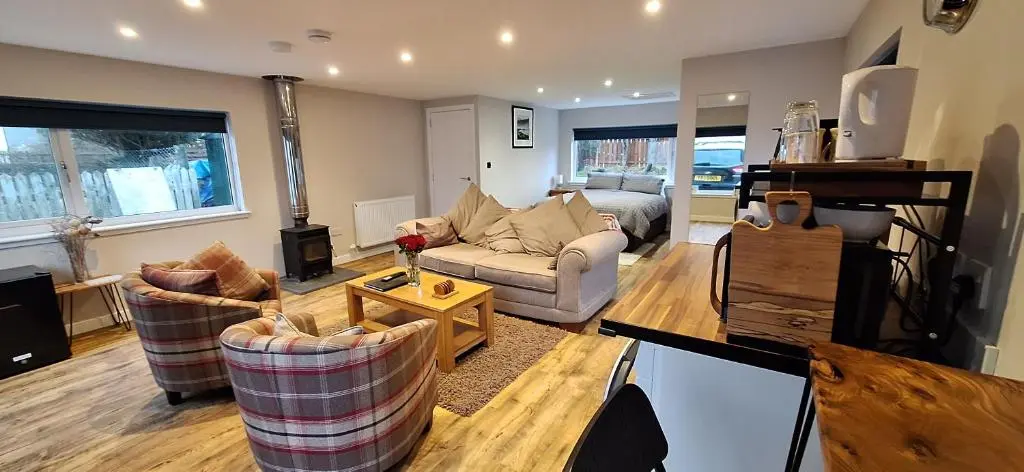 a living room with a couch and a table at CeolMara in Ullapool