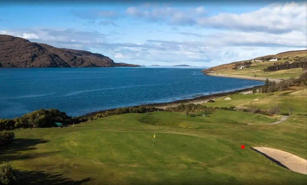 a golf course with a view of the water at Loch Broom Glamping in Garve