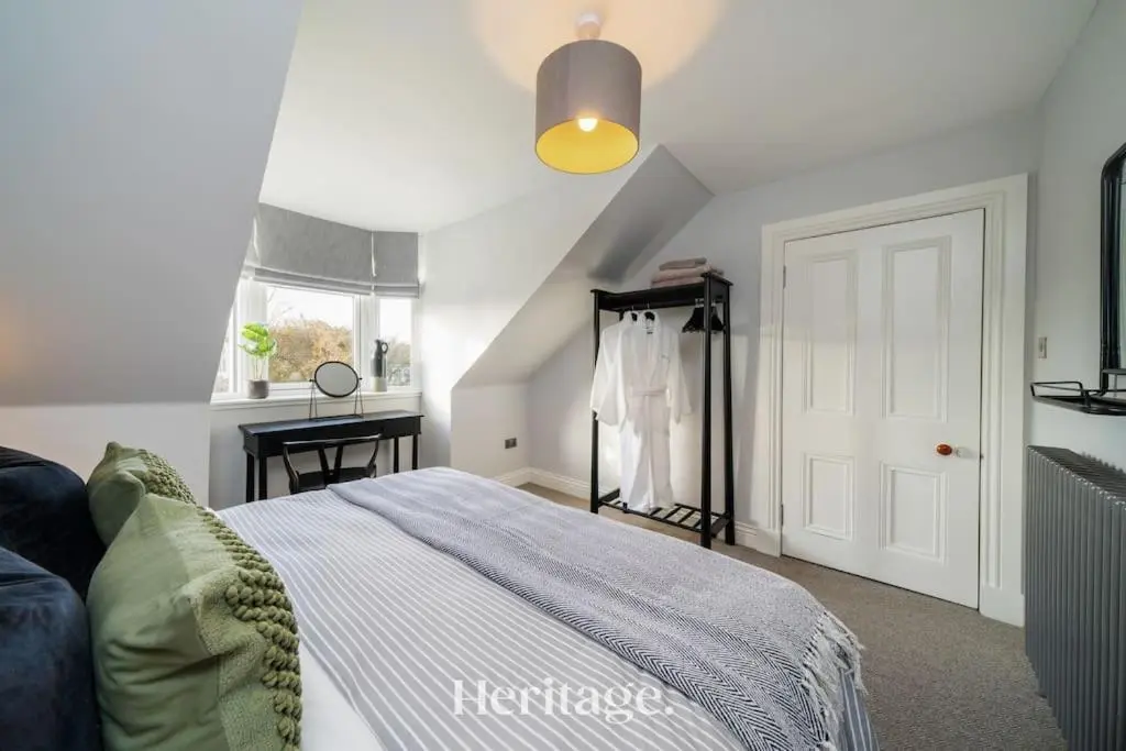 a white bedroom with a bed and a window at Blythewood Aberdeenshire Luxury Lodge with Hot Tub in Kemnay