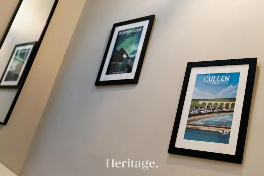 a group of framed pictures hanging on a wall at Blythewood Aberdeenshire Luxury Lodge with Hot Tub in Kemnay