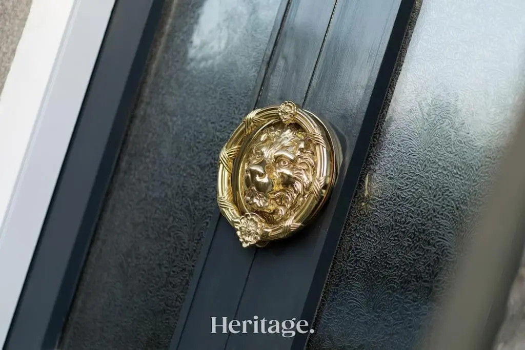 a gold pin of a face on a black door at Blythewood Aberdeenshire Luxury Lodge with Hot Tub in Kemnay