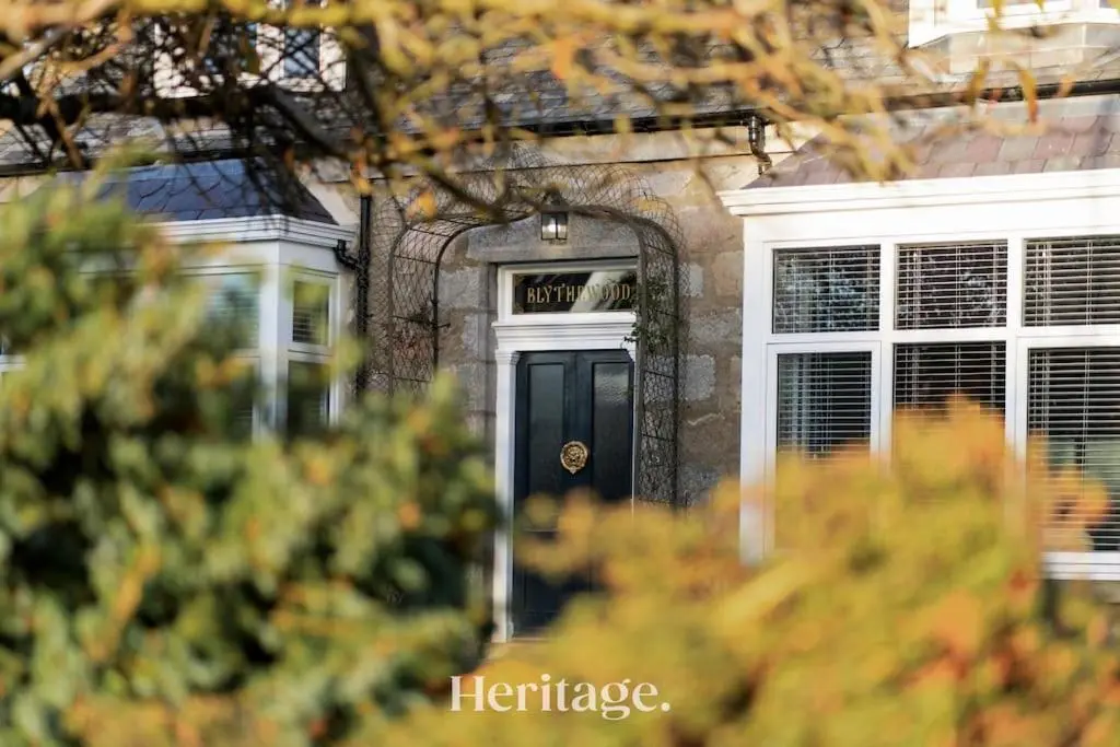 a brick house with a black door and windows at Blythewood Aberdeenshire Luxury Lodge with Hot Tub in Kemnay