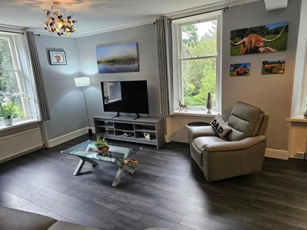 a living room with a couch and a tv at Cosy highland getaway in Grantown on Spey