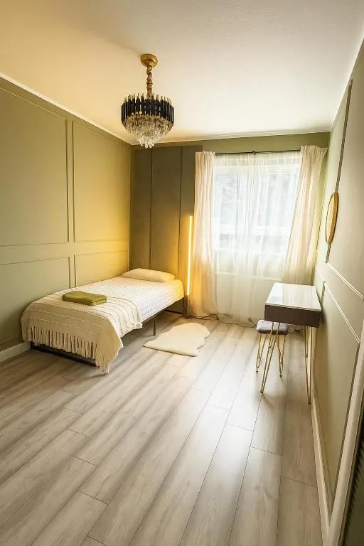 a bedroom with a bed and a chandelier at Cosy Laurel Nest Near Loch Ness in Inverness