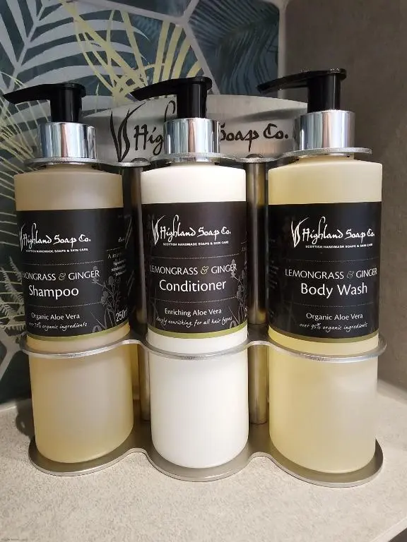 a group of four candles sitting on a shelf at Woodland Lodge in Huntly