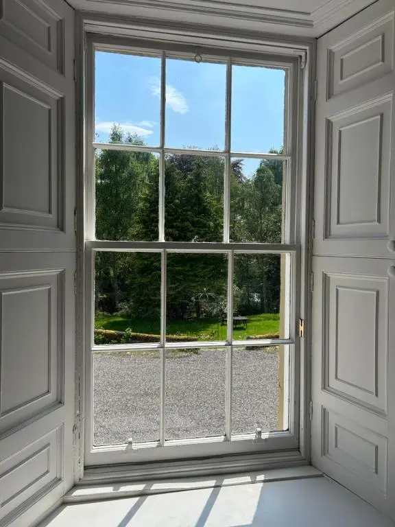an open window with a view of a yard at Estate Of Ord in Muir of Ord