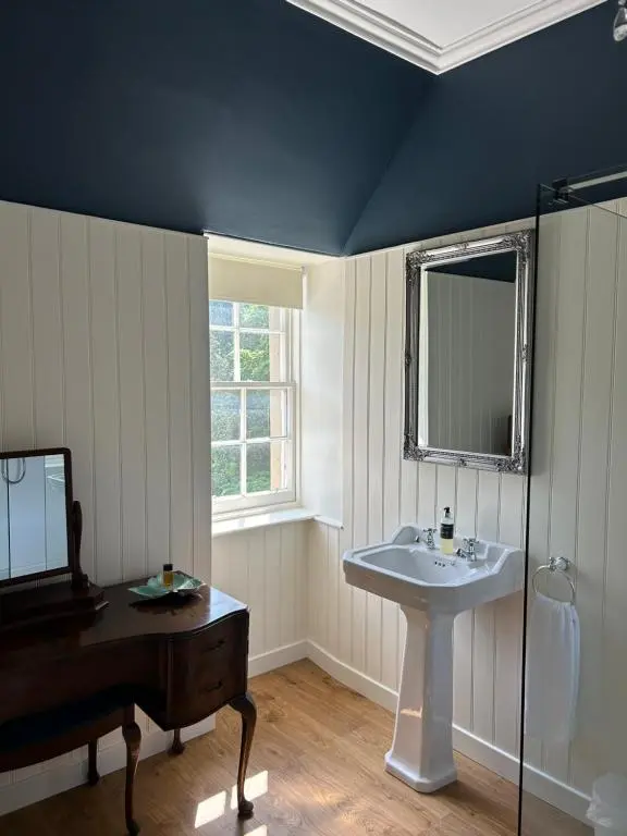 a bathroom with a sink and a mirror at Estate Of Ord in Muir of Ord
