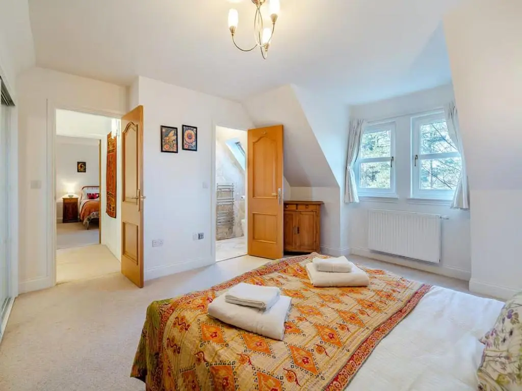 a bedroom with a large bed with two towels on it at Stunning 4 bed rural retreat in Aberlour in Aberlour
