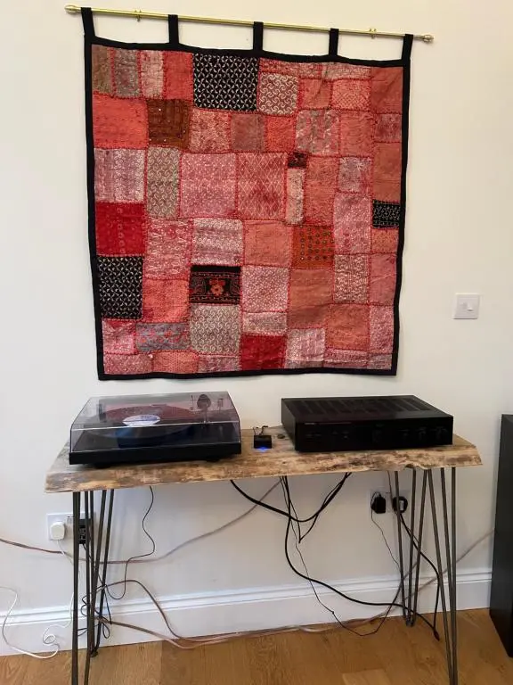 a quilt hanging on a wall next to a table at Stunning 4 bed rural retreat in Aberlour in Aberlour