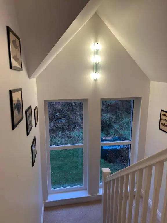 a room with two windows and a staircase at Stunning 4 bed rural retreat in Aberlour in Aberlour