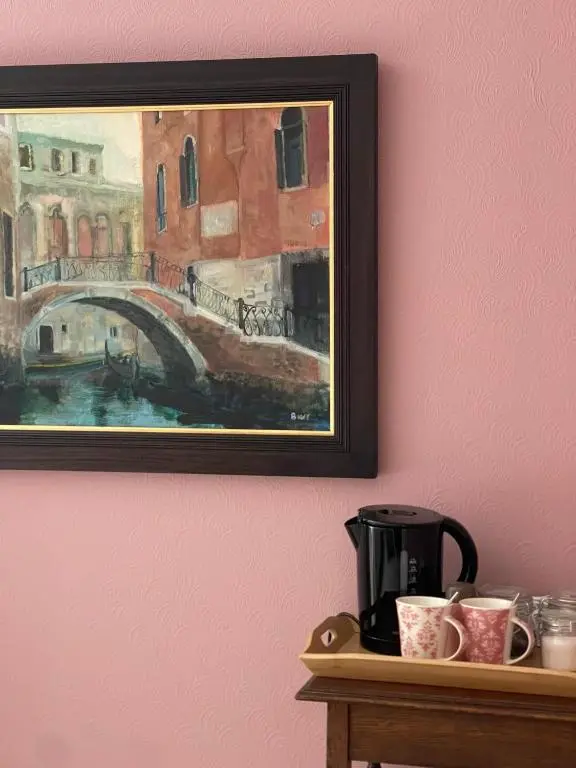 a painting of a bridge and cups on a table at Runnymede House in Inverness