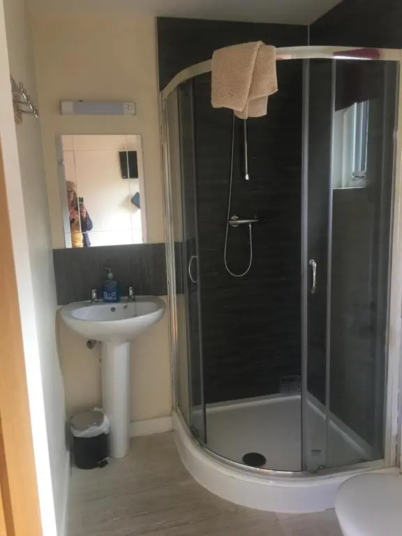 a bathroom with a shower and a sink at 1 Lochness Rooms&Hostel in Drumnadrochit