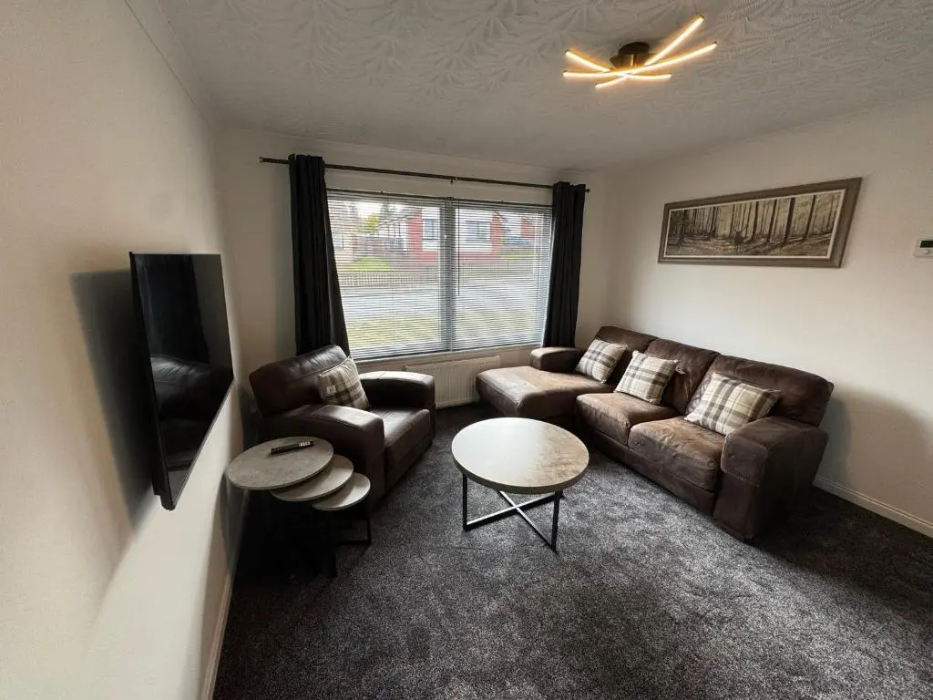 a living room with a couch and chairs and a table at Firth View Heights in Inverness