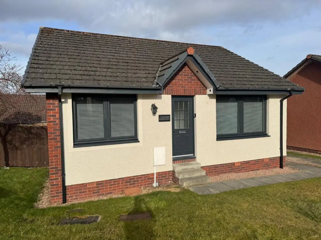 a small house with a black roof at Firth View Heights in Inverness
