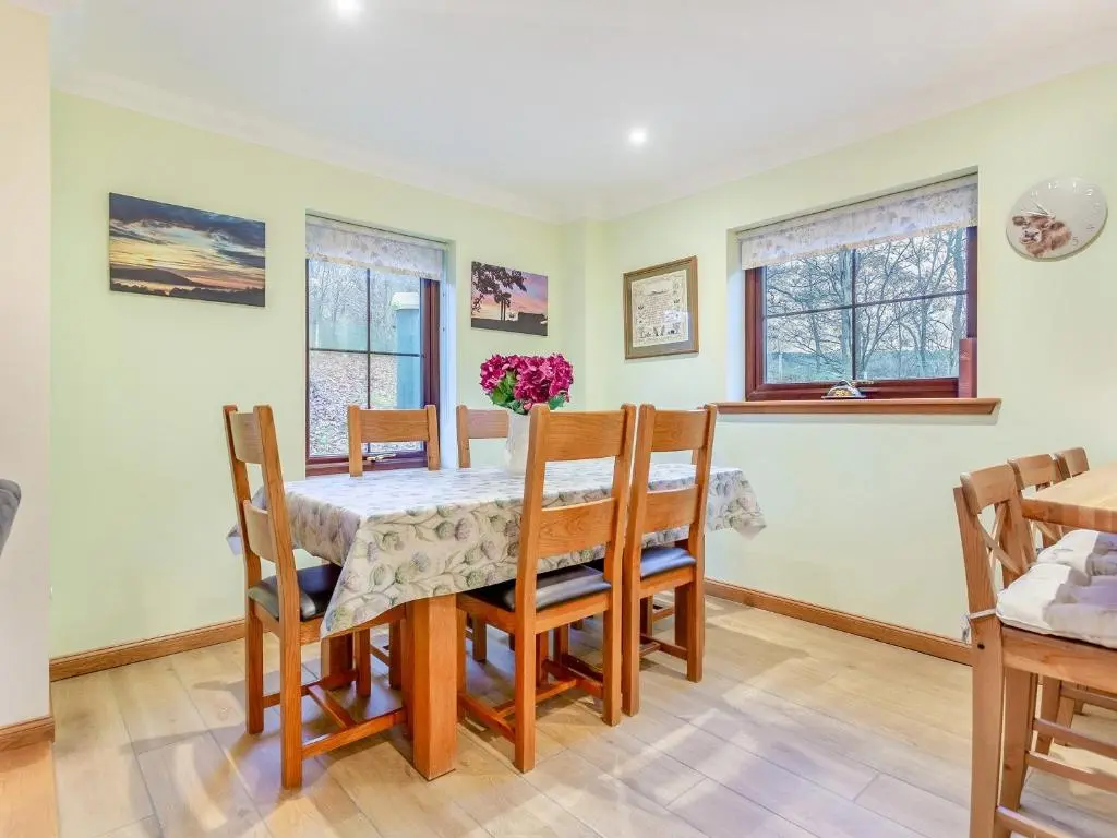 a dining room with a table and chairs at Bunchrew Farm Cottage in Inverness